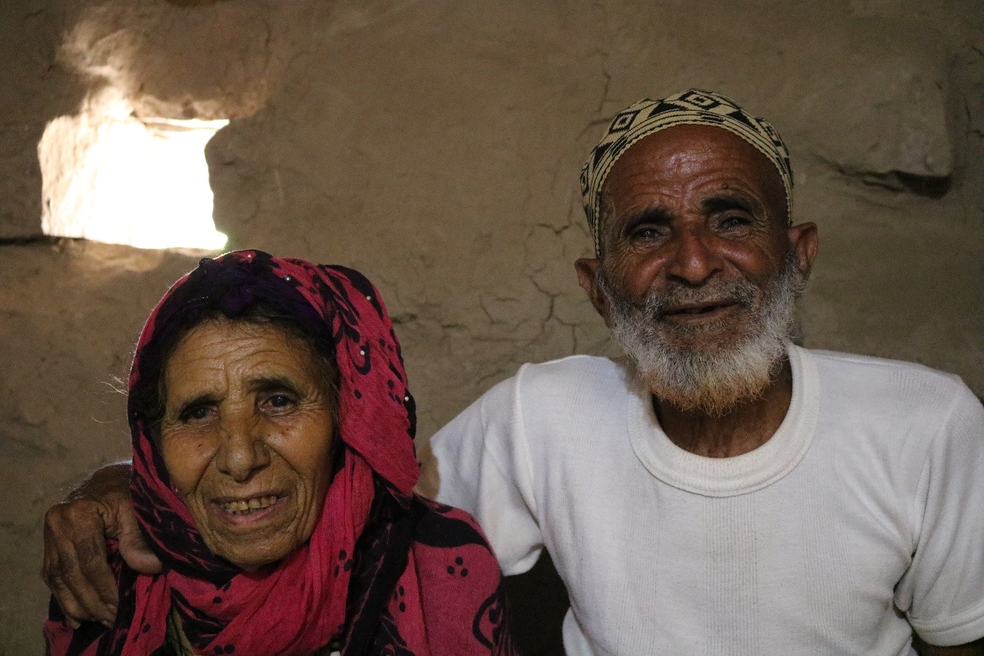 An old man and woman smiling
