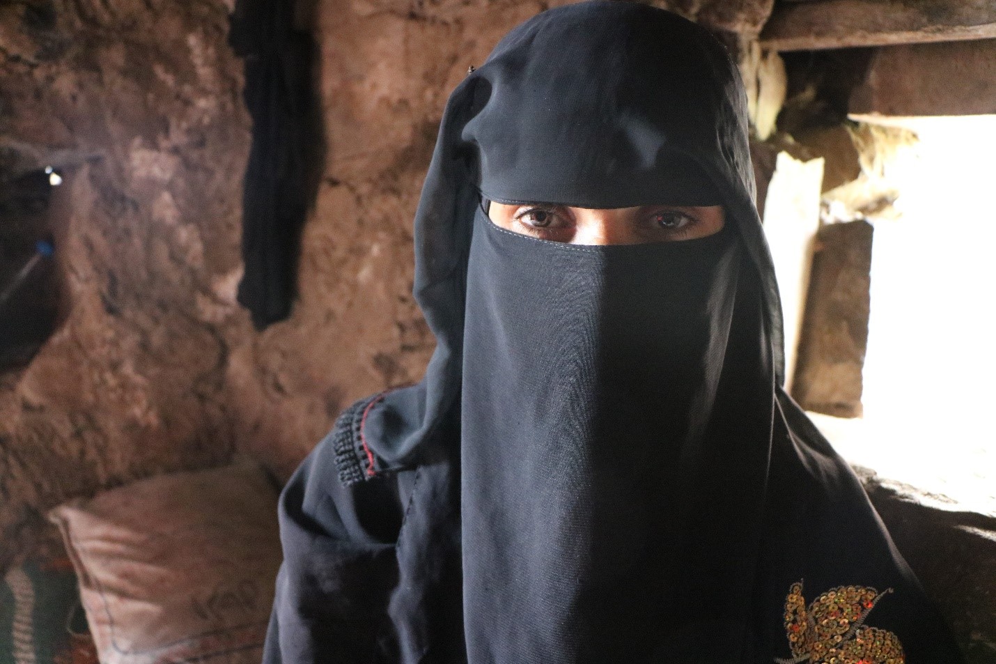 A woman wearing a black burqa