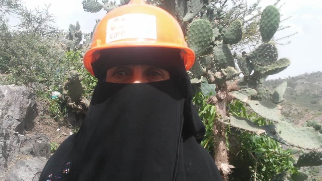 A woman wearing an orange helmet