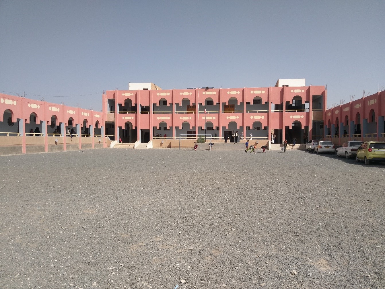 A building with many windows and a gravel area