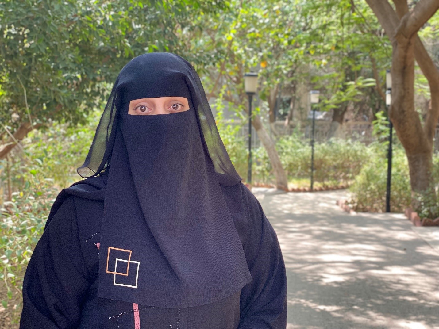 a woman wearing a black head covering