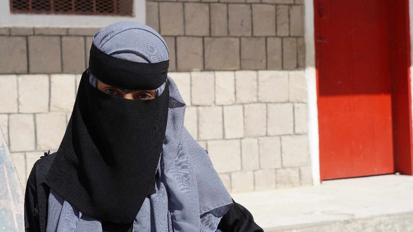 A woman wearing a black head covering