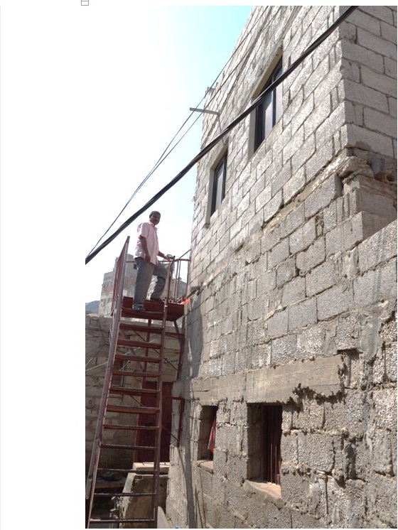 A man standing on a ladder