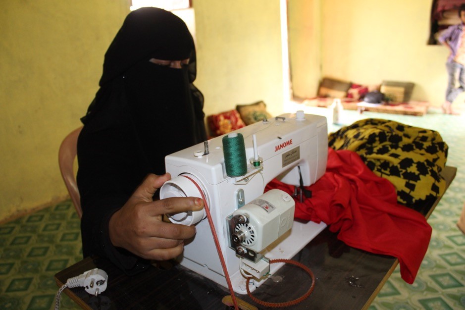 A woman sewing on a sewing machine