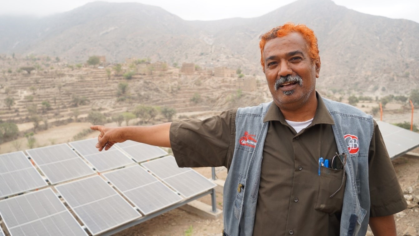 A man pointing to a newly built solar panels