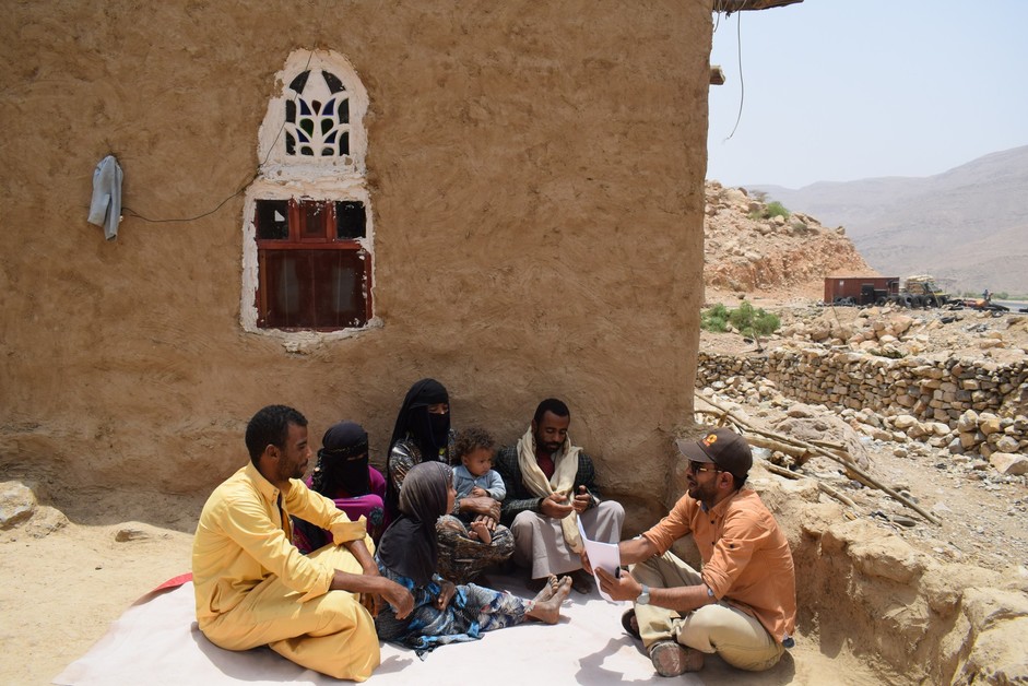 A group of people sitting outside a building
