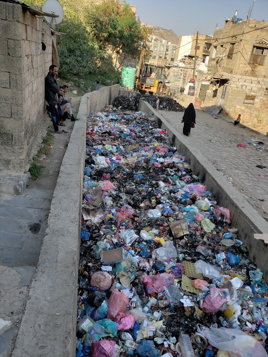 a large pile of garbage in a canal
